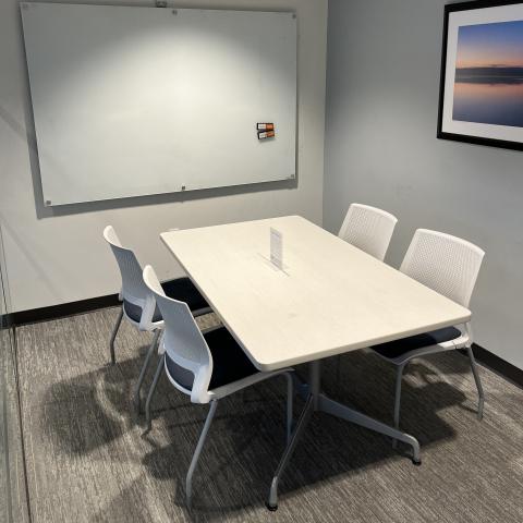 white table, whiteboard, four chairs