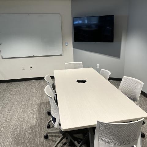 room with table, 6 chairs, whiteboard, TV