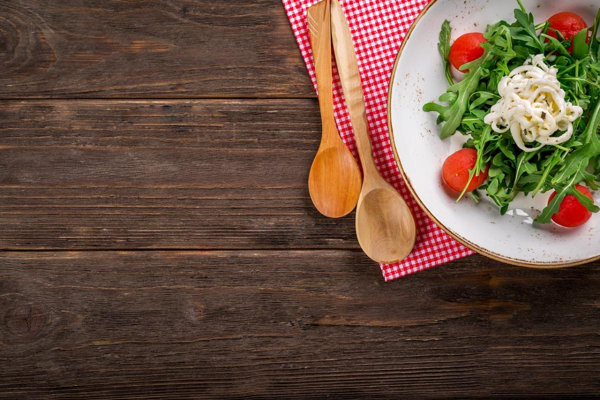 table with spoons and salad